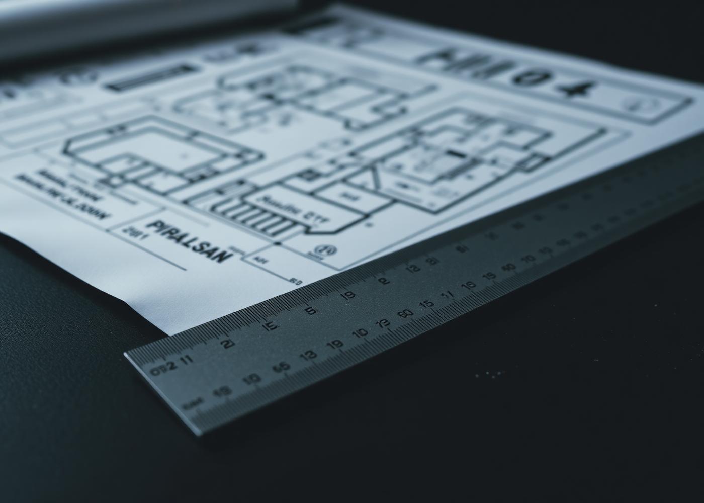 Architectural drawings on a dark desk